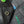 Close-up of a black denim jacket with a button, embroidered design, and brand label.