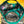 Close-up of the inside of a camouflage baseball cap with bright teal trim and a brown leather strap, laid on a yellow wooden surface.