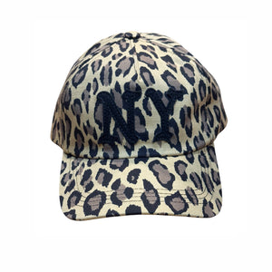 A baseball cap featuring a beige, gray, and black leopard print pattern with a prominent black embroidered 'NY' logo on the front, set against a plain white background.